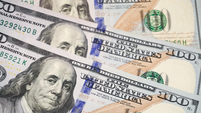 Multiple US $100 bills featuring Benjamin Franklin are 
