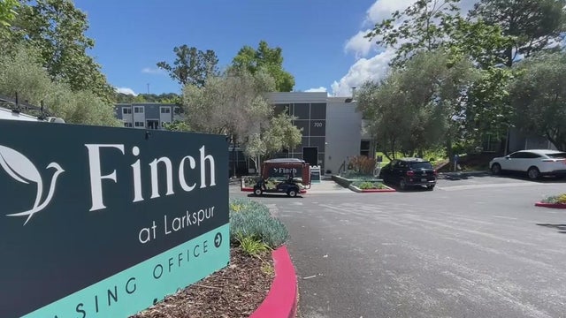 A sign in at the entry way of an apartment complex 