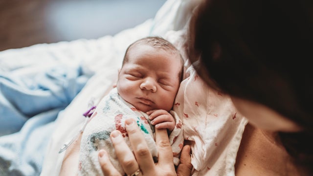 Mother holding newborn baby 