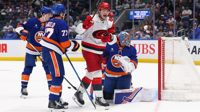 Eric Robinson #50 of the Carolina Hurricanes celebrates a third period goal by Mark Jankowski #77 against David Rittich #33 of the New York Islanders at UBS Arena on April 14, 2026 in Elmont, New York. 