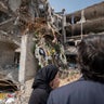A foreign diplomat reacts while visiting a site attacked during U.S.-Israeli military operations in Tehran, Iran, April 20, 2026. 
