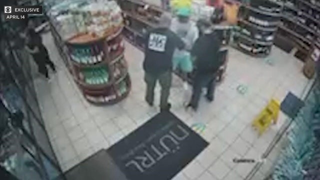Timothy Brown being approached in a liquor store by two NYPD officers 