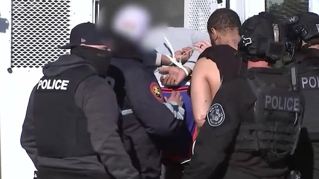 Police place two people in vehicle 