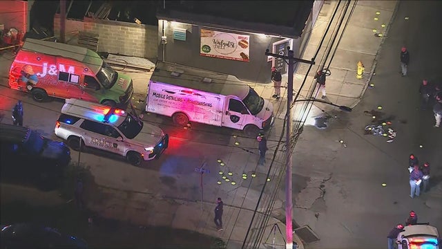 Close Up Shot Focused on Yellow Tape Showing Text Police Line Do Not Cross. Restricted Area of a Crime Scene. Bokeh Background with Flickering Siren Lights. Forensics Team Working on a Case 