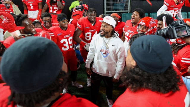 Coach DeSean Jackson of Delaware State University celebrates with his team after a win 