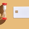 Time management concept with hourglass and blank credit card on beige 