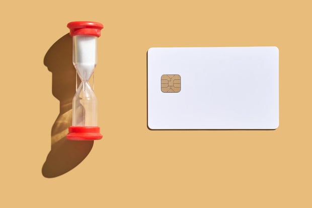 Time absorption   conception  with hourglass and blank recognition  paper  connected  beige 