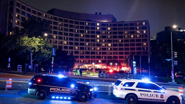 Police cars with their lights on are seen outside the Washington Hilton 