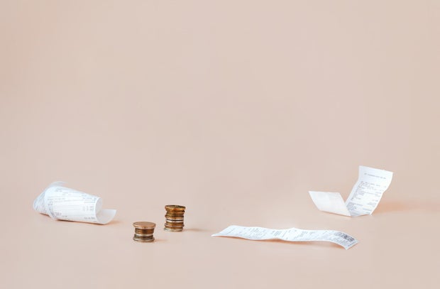 Cost of living. Сoins and payment receipts. Abstract minimalistic composition with copy space.  World crisis, stagnation, inflation, and rising of prices concept 