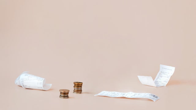 Cost of living. Сoins and payment receipts. Abstract minimalistic composition with copy space. &nbsp;World crisis, stagnation, inflation, and rising of prices concept 