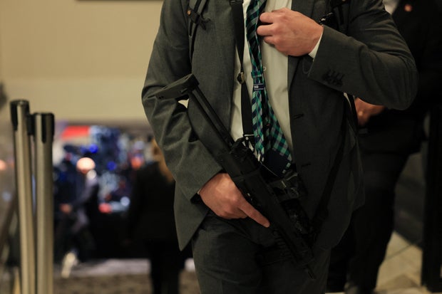 An agent holds a small automatic weapon as he guards a stairway after shots were fired during the White House Correspondents' Dinner at the Washington Hilton in Washington, D.C., on April 25, 2026. 