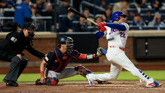Juan Soto #22 of the New York Mets hits a two run home run as Drew Millas #14 of the Washington Nationals and umpire Laz Diaz #63 look on in the fourth inning at Citi Field on April 28, 2026 in the Flushing neighborhood of the Queens borough of New York City. 