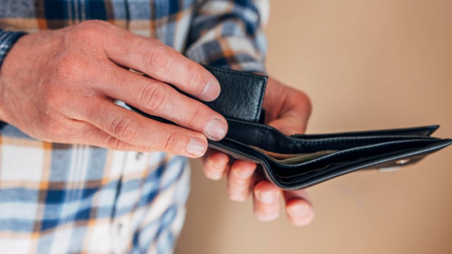 male hands holding an open wallet 
