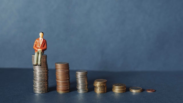 Elderly people sitting on coin, Time counting down for retirement concept, social security income and pensions 