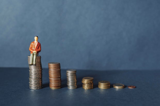 Elderly people sitting on coin, Time counting down for retirement concept, social security income and pensions 