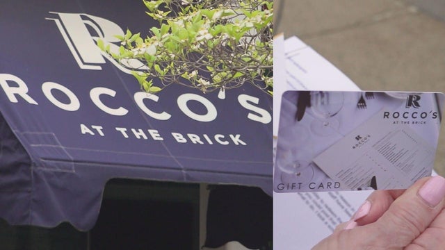 Gift cards from a variety of businesses available for sale at a store 