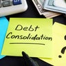 Debt consolidation written by hand and money. 