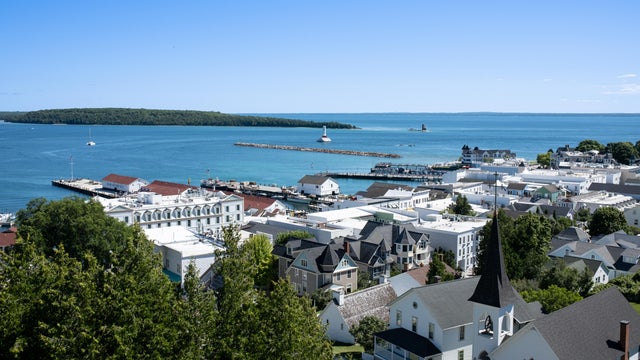 High angle view of townscape by sea against clear blue sky,Mackinac Island,Michigan,United States,USA 