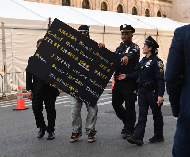 A protester holds a sign outside the 2026 Met Gala celebrating "Costume Art" at Metropolitan Museum of Art on May 04, 2026 in New York City. 