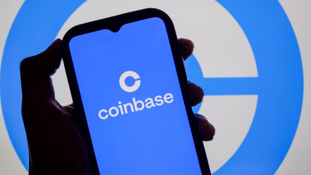 In this photo illustration, the Coinbase logo is displayed 