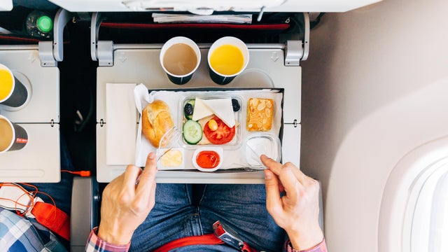 Eating airplane food during a flight, personal perspective directly above view 