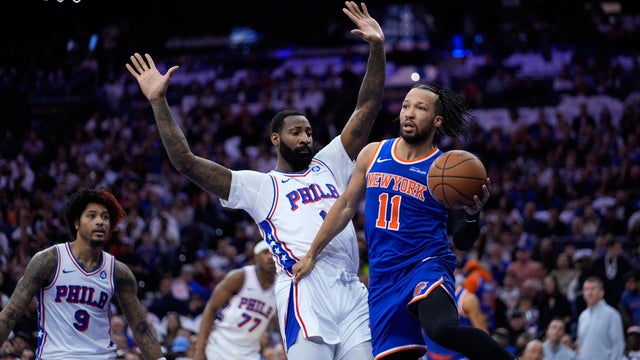 New York Knicks' Jalen Brunson, right, passes against Philadelphia 76ers' Andre Drummond during the first half of Game 3 in a second-round NBA basketball playoff series Friday in Philly 