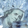 Close up frozen one hundred US dollar bill banknote with ice cubes. 