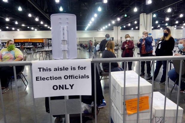Election officials perceive  arsenic  procedural issues are argued during a ballot recount astatine  the Wisconsin Center successful  Milwaukee, Wisconsin, connected  Nov. 20, 2020. 