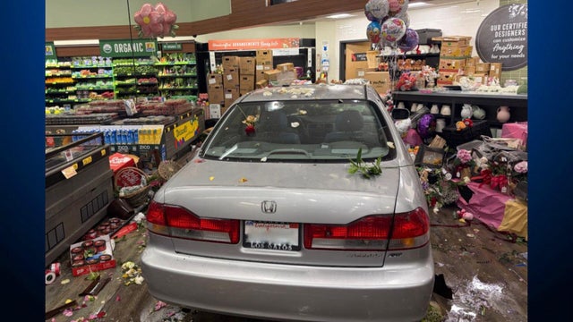 a vehicle with debris on it inside of a grocery store 