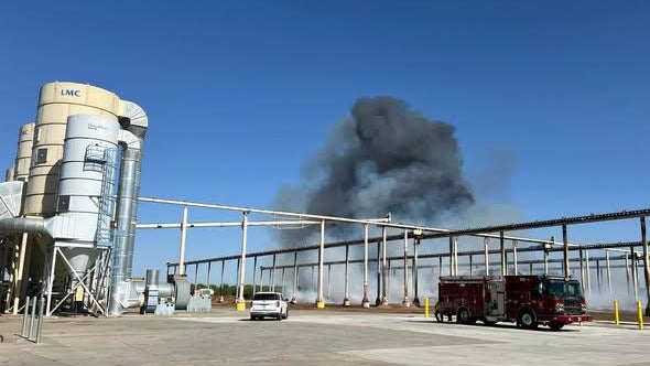 smoke seen from behind an industrial location 