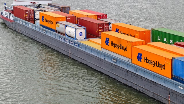 Freight Ship Carries Containers On The Rhine Near Mainz 