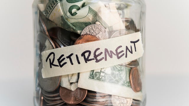 Money in jar labeled 'retirement' 