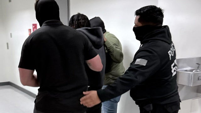 Man being taken into custody by ICE agents 