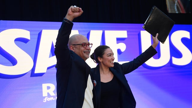 Chris Rabb and Rep. Alexandria Ocasio-Cortez on stage during a campaign event for Rabb 