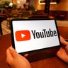 In this photo illustration, the YouTube logo is displayed on 