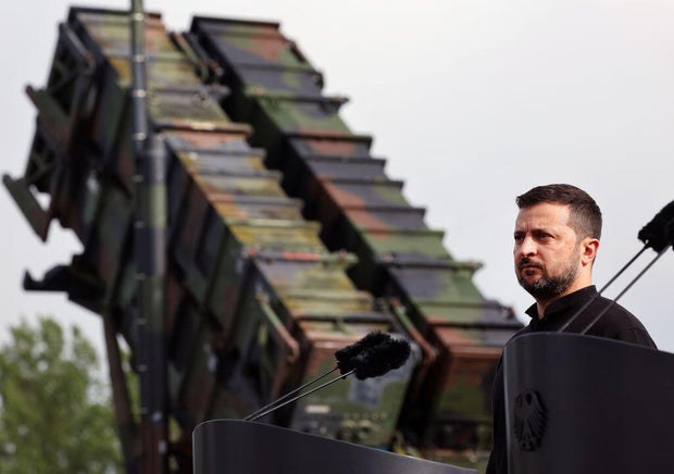 Ukrainian President Volodymyr Zelenskyy stands in front of a Patriot air defense missile system at a military training area in Germany on June 11, 2024. 