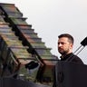 Ukrainian President Volodymyr Zelenskyy stands in front of a Patriot air defense missile system at a military training area in Germany on June 11, 2024. 