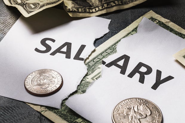 The inscription salary is torn in half. Concept on the financial crisis. There will be no salary 