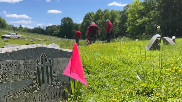 A small pink flag marks something near a gravestone at Mount Zion Cemetery in Collingdale 
