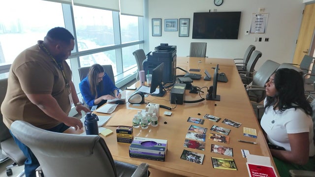 Forensic scientists sit with a woman whose father is missing 