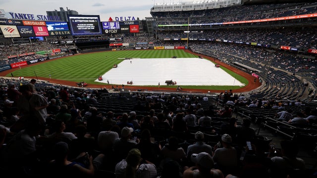 A tarp lies over the field prior to first pitch between the New York Yankees and the Boston Red Sox at Yankee Stadium on June 06, 2026 in the Bronx borough of New York City. 