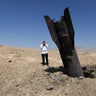 An Israeli ultra-Orthodox Jewish man reacts near a missile protruding from the ground following strikes from Iran in the central Israeli-occupied West Bank, June 8, 2026. 