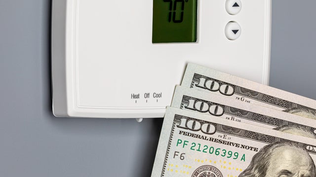 Thermostat for home furnace and air conditioner. Utility bill savings, energy cost and conservation concept 