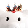 Figurine on wheelchairs on piggy bank 
