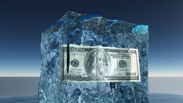 One hundred dollar bill frozen in ice 