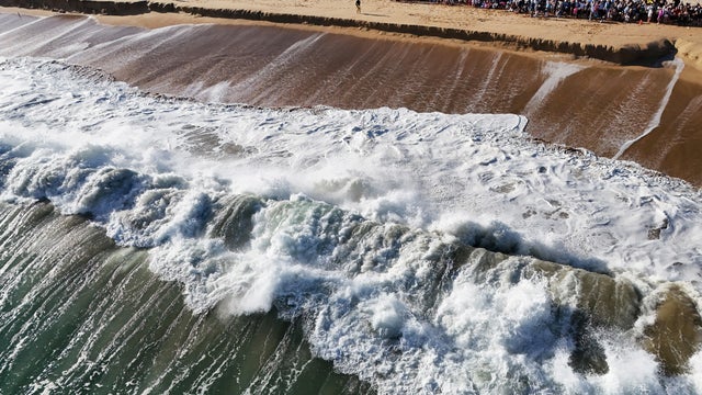 Massive Swells Draw Surfers To Orange County, California 