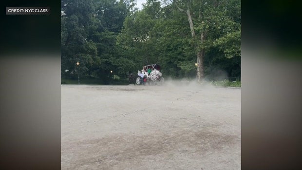 A horse pulls a carriage that is leaning on two wheels as the horse sprints.