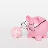 A big pink mother piggy bank wearing spectacles and a smaller one on a white background. Illustration of the concept of investment, fund and planning for children education 