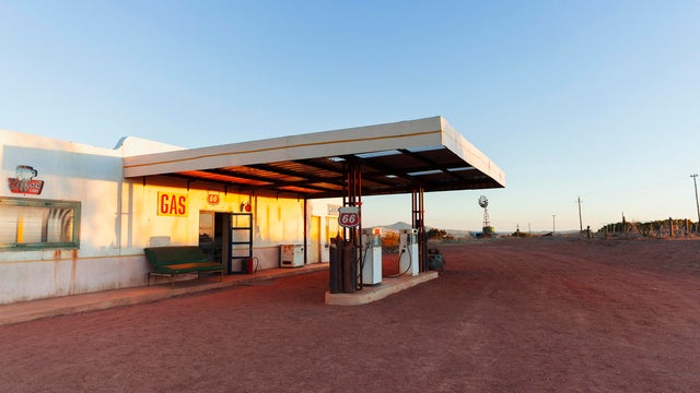 Abandoned gas station and garage at sunset 