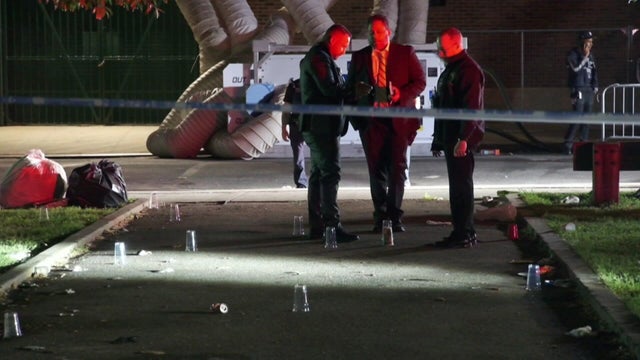 Evidence markers on ground with cops nearby 